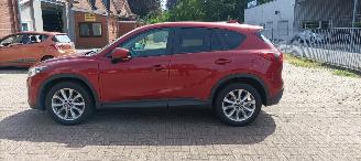 Damaged car Mazda CX-5 2.2 175pk Automatik 4x4 Navigatie Xenon Climatecontrol CruiseControl Stoelverwarming Lichtautomaat Privacyglas Regensensor Achteruitrijcamera Keyless entry 2014/7